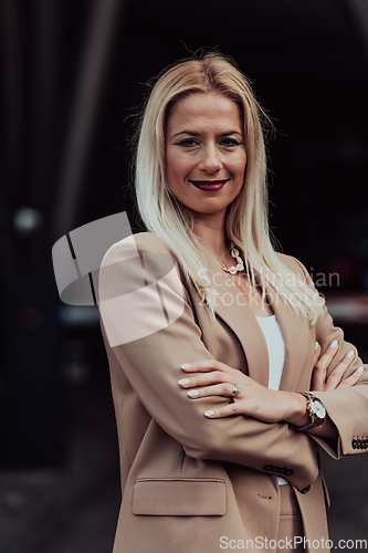 Image of A powerful portrait of a businesswoman, standing confidently with her arms crossed, representing the determination of the female gender and embodying strength and success