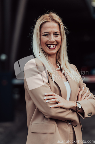 Image of A powerful portrait of a businesswoman, standing confidently with her arms crossed, representing the determination of the female gender and embodying strength and success