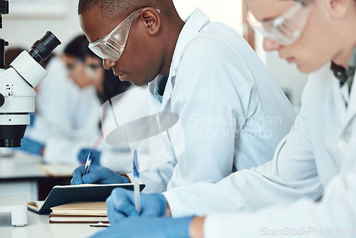 Image of Science students, research and writing in laboratory, experiment and healthcare innovation. Researchers, notebooks and make notes for medical scientific methods, exams and analysis for cure and focus