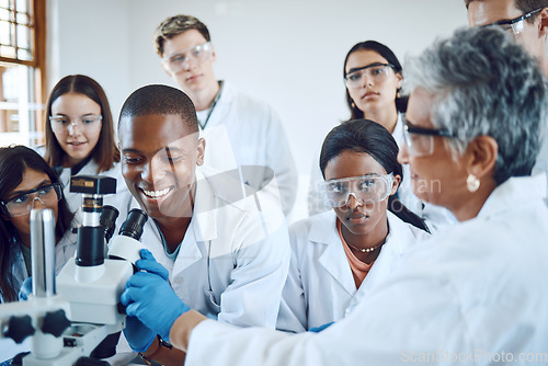 Image of Education, science and teacher with students using microscope for chemistry, biology and medical research . Medicine, healthcare lab and mentor with university class to study analytics of dna sample