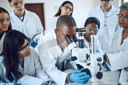 Image of Teamwork, collaboration and group of scientists with microscope for experiment. Science, laboratory and team of people or doctors with books and equipment for medical research, analysis and testing.