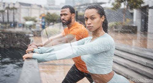 Image of Portrait, couple in the rain or stretching for workout, fitness or wellness. Wet, man or woman training, practice routine or motivation for health, commitment or sports for energy, cardio or exercise