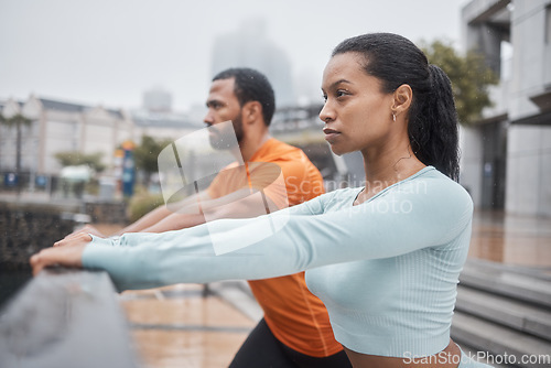 Image of Fitness, runner and couple stretching in city for workout and health mindset preparation in Chicago, USA. Focused people warm up stretch for urban running, exercise and endurance together.