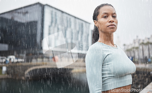 Image of Fitness, motivation and black woman in rain in city for workout, marathon training and running. Sports, winter and portrait of female athlete exercise for healthy lifestyle, wellness and inspiration