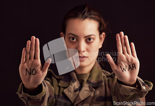 Image of Soldier portrait and stop hands for war protest of asian woman with political palm statement. Serious, unhappy and army girl frustrated with violence in Ukraine with black studio background.
