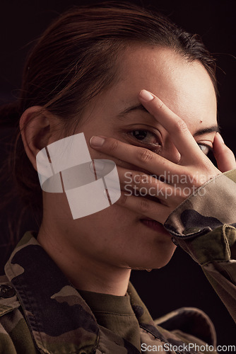 Image of Soldier woman, mental health and hand on face in studio for depressed, anxiety or stress in war clothes. Military ptsd, trauma memory and army portrait by black background with depression in Ukraine