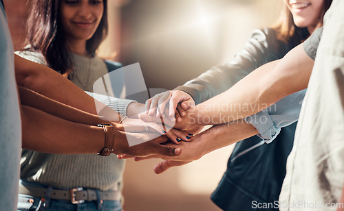 Image of Diversity, hands together and team support for student collaboration, education motivation and team building project success. Interracial group of collge friends, solidarity and goals mission