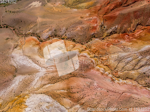 Image of Aerial shot of the textured yellow nad red mountains resembling the surface of Mars