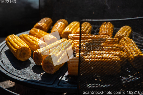 Image of A professional cook prepares corn