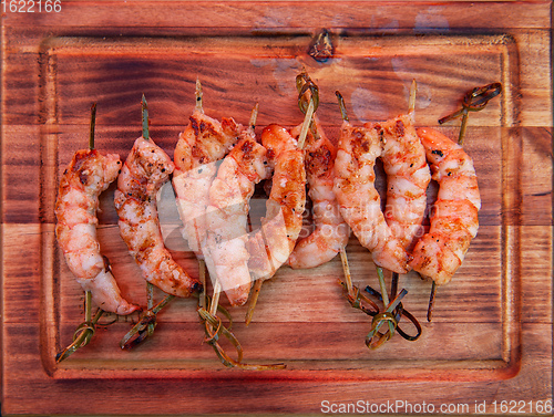 Image of A professional cook prepares shrimps