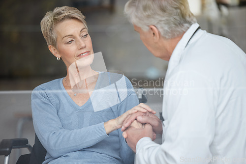 Image of Disability patient, holding hands and doctor with help, support and trust in physical therapy, healthcare and therapy service. Medical worker, empathy hand holding and consulting woman in wheelchair