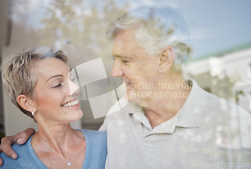 Image of Love, hug and window with senior couple, smile and retirement for bonding, romance and relationship. Romantic, man and woman embrace, marriage and happiness for intimate quality time and glass.