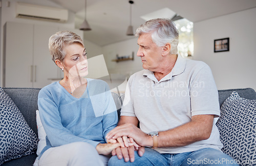 Image of Elderly couple, holding hands and living room of people with support from sad news at home. Senior, retirement and elderly care kindness showing trust, love and marriage care in a family house