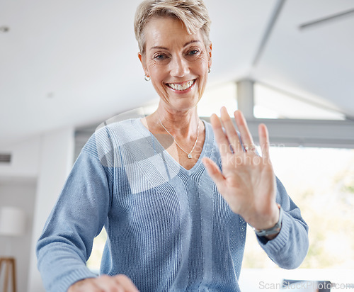 Image of Senior woman, hand and waving on video call, house zoom conference or social networking communication in house or Canada home. Portrait, smile and happy retirement elderly with hello greeting gesture