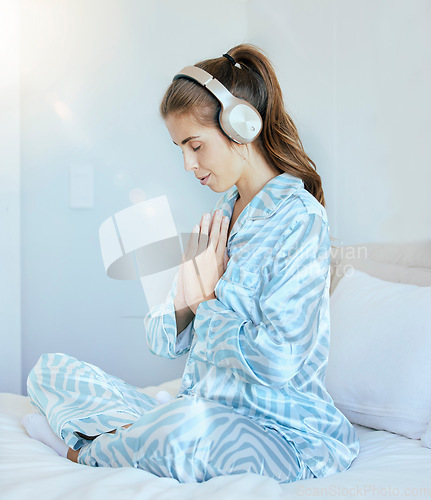 Image of Woman, music headphones or namaste meditation in house bedroom, home or hotel for mental health, stress management or zen. Calm, peace or yogi listening to relax radio podcast in mind prayer training