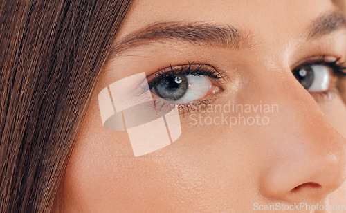 Image of Woman, face or skincare glow and blue eyes for vision, cybersecurity innovation for retina scan ideas for future ai. Zoom, portrait or texture for model eyebrows, eyelashes or facial makeup cosmetics