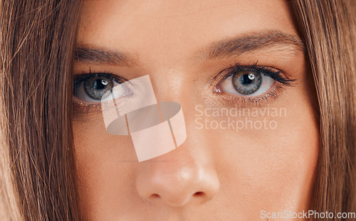 Image of Woman, eyes and face in vision for sight, beauty or awareness staring with facial cosmetics or makeup. Closeup portrait of female looking in eyesight, skincare or microblading eyebrows and eyelashes