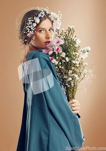 Image of Aesthetic woman, beauty and flowers on studio background for cosmetics, skincare and dermatology during spring in Amish culture. Portrait of female model with flower for natural nature fashion style