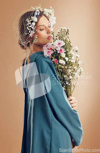 Image of Floral crown, fashion and woman with flowers in studio isolated on a brown background. Beauty, makeup and aesthetics of female model from Canada in dress with plants or organic cosmetics for skincare