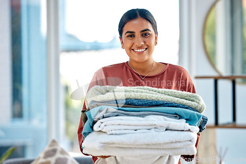 Image of Portrait, cleaning or woman with laundry or happy smile after washing clothes or towels in cleaning services. Hospitality, hotel or face of Indian cleaner working at a airbnb, house or home in Mumbai