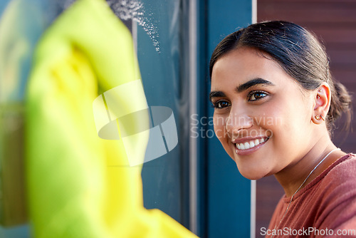 Image of Woman, cleaning and window washing with a smile to clean windows dirt with water, soap and fabric. Happy Indian person cleaner or maid doing spring cleaning with happiness for housekeeping helping