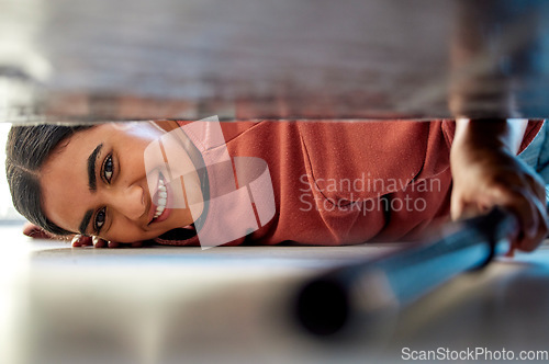 Image of Woman cleaning under a bed in bedroom with vacuum for the floor to clean dust, dirt or bacteria. Happy, smile and portrait of housewife or maid disinfecting the ground of house while spring cleaning.