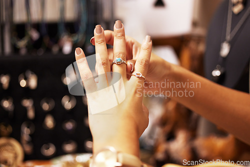 Image of Jewellery, boutique and hand of woman with ring in shopping mall, retail shop and designer store. Fashion, cosmetics and close up of hands of female customer trying on luxury rings with gemstone
