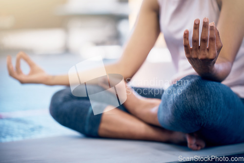 Image of Yoga, zen and woman doing a meditation exercise in gym with lotus pose for calm, peace and balance. Mindfulness, energy and girl doing pilates workout for mind, body and spiritual health and wellness