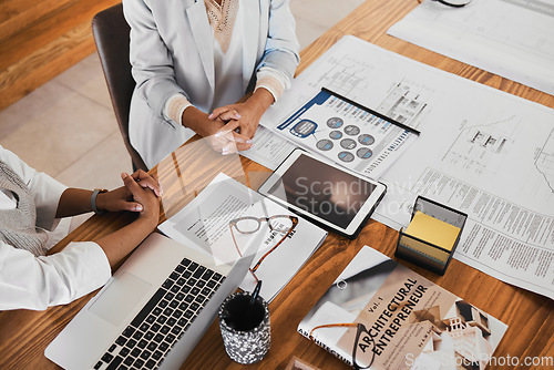 Image of Architecture, planning and hands on desk with laptop in meeting with paperwork, illustration and documents. Teamwork, collaboration and architects in discussion with proposal, blueprints and notebook