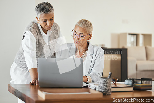 Image of Laptop, office and senior business women in collaboration planning a corporate project together. Teamwork, professional and elderly manager helping a mature employee with a report in the workplace.