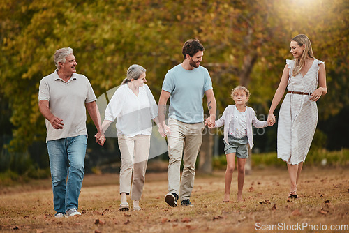 Image of Family, walking and holding hands outdoor with mother, dad and girl happy with grandparents. Happy family, love and parent care in nature with a child in a grass field park in autumn on holiday