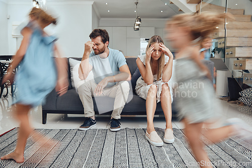 Image of Kids running, parents on sofa tired and chaos in living room with frustrated mom and dad burnout. Happy children, parenting stress and excited girl and boy with energy play, woman and man in crisis