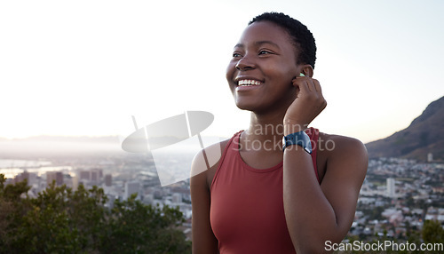 Image of Fitness, headphones or black woman in nature to start running exercise, cardio workout or marathon training. Sunset, earbuds or happy African girl streaming radio music, podcast or audio playlist