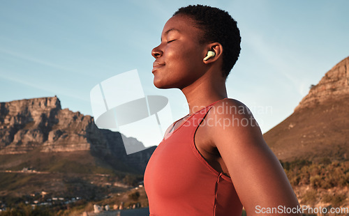 Image of Calm black woman, outdoor fitness and breathing in nature, Cape Town mountains and meditation of motivation, health or relax mindset. Female athlete, breathe and workout peace for zen sports wellness