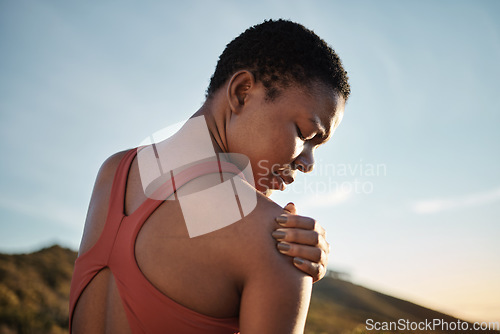 Image of Shoulder, black woman and exercise injury from outdoor sports training on sky background. Athlete, arm and joint pain, muscle problem and first aid emergency from wound, fitness and workout mistake