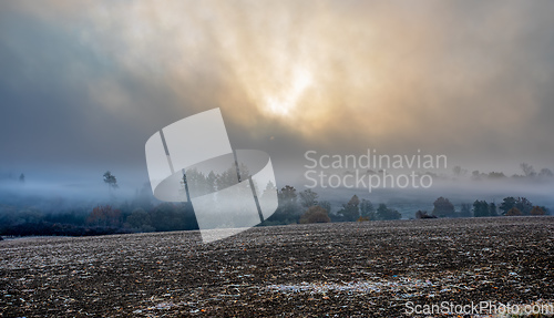 Image of Autumn foggy and misty sunrise landscape