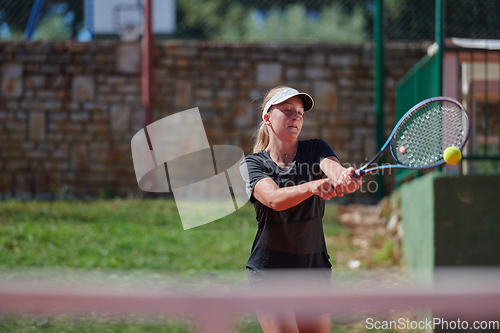 Image of A young girl showing professional tennis skills in a competitive match on a sunny day, surrounded by the modern aesthetics of a tennis court.