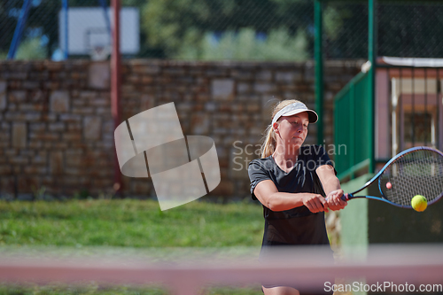 Image of A young girl showing professional tennis skills in a competitive match on a sunny day, surrounded by the modern aesthetics of a tennis court.