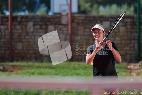 Image of A young girl showing professional tennis skills in a competitive match on a sunny day, surrounded by the modern aesthetics of a tennis court.