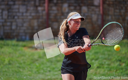 Image of A young girl showing professional tennis skills in a competitive match on a sunny day, surrounded by the modern aesthetics of a tennis court.