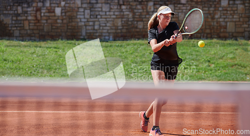 Image of A young girl showing professional tennis skills in a competitive match on a sunny day, surrounded by the modern aesthetics of a tennis court.