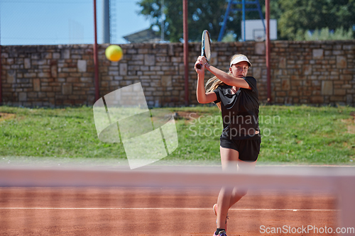 Image of A young girl showing professional tennis skills in a competitive match on a sunny day, surrounded by the modern aesthetics of a tennis court.