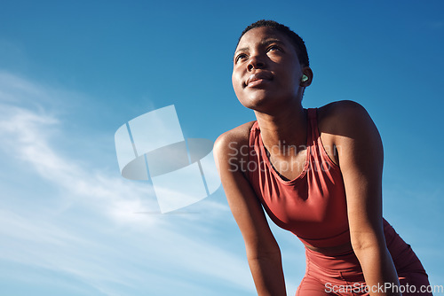 Image of Black woman, exercise or tired after training, running or workout for balance, wellness or health outdoor. Sky, African American female, runner or athlete relax, breathing or focus for cardio or rest