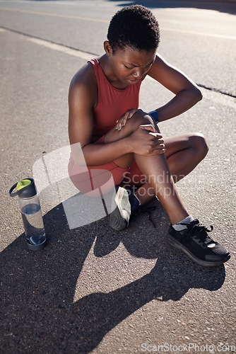 Image of Fitness, knee and black woman injury, after training and workout with agony, emergency and outdoor. African American female, runner and athlete with pain, suffering and discomfort on road and hurt.