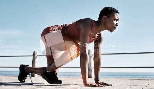 Image of Black woman, fitness and runner with knee x ray in sports training, workout or exercise in the outdoors. Determined African American woman getting ready for running, race or sprint in motivation