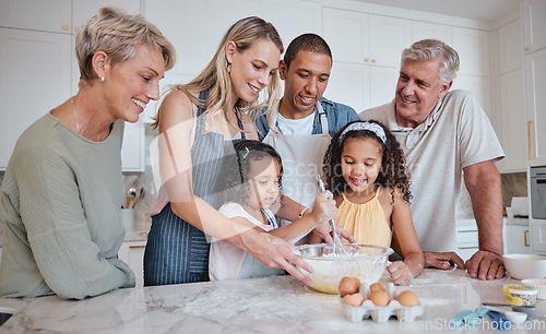Image of Family in kitchen, baking and grandparents with kids, parents and bonding for quality time, love and smile together. Mother, father and daughters with grandmother, grandfather and cooking on weekend.