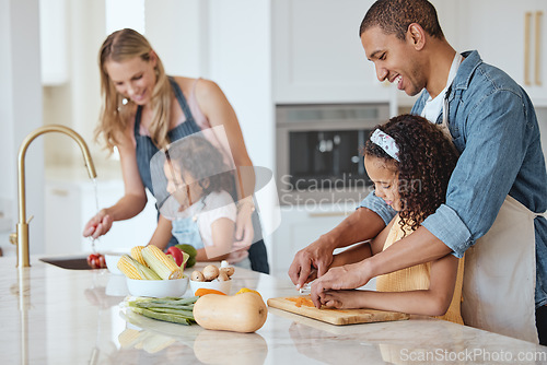 Image of Family, mother and father with girls, vegetables or cooking together, interracial or bonding. Love, man and woman happy with daughters, cutting or rinse veggies in kitchen, child development or relax