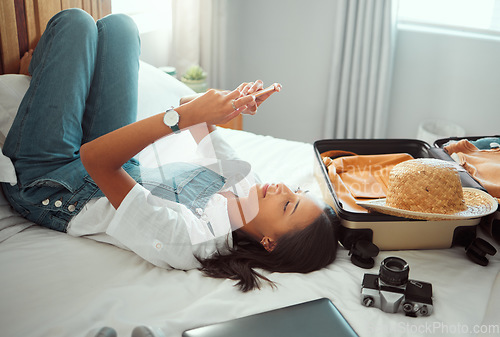 Image of Travel communication, relax and woman with a phone on holiday for social media, mobile app and influencer update. Chat, internet and girl typing on a mobile during a hotel vacation for a blog