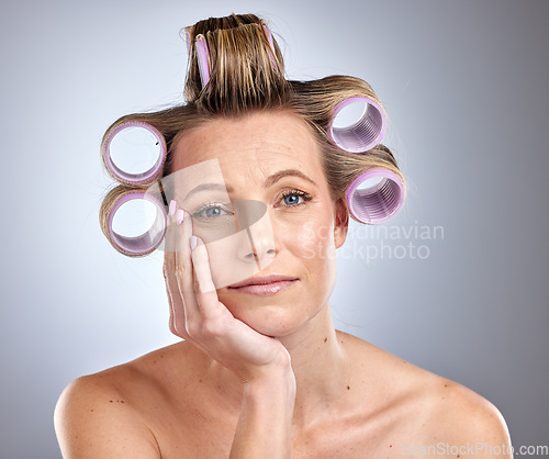 Image of Woman, face and waiting for hair roller set, bored and hair style on studio background. Portrait of model, hair care and curlers for cosmetics, beauty salon treatment and makeup product on backdrop