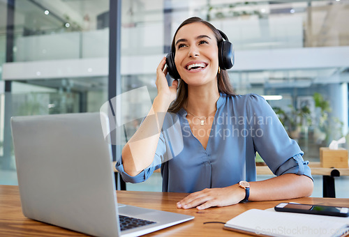 Image of Music, headphones and business woman in office streaming radio or podcast. Break, thinking and happy female employee from Canada on desk with laptop listening to song, audio or sound at workplace.